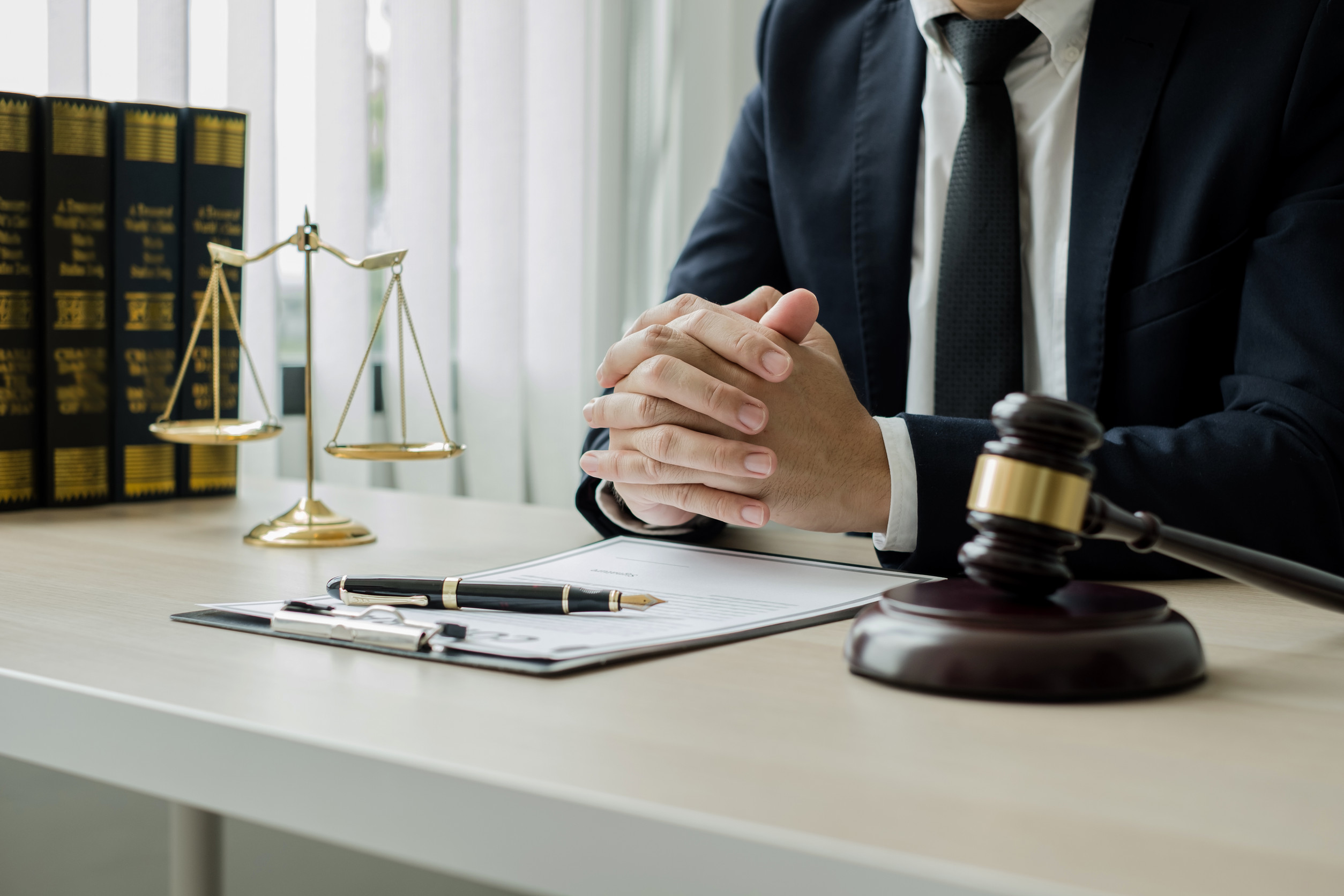A man sitting at a desk with a gavel and a gavel.