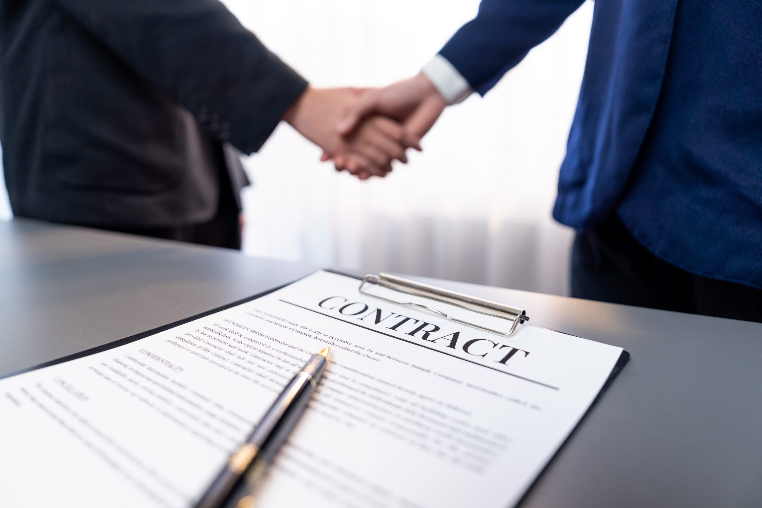 Shaking hands over a contract
